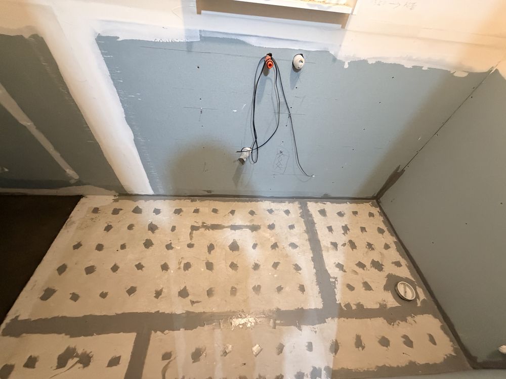 Screeded and waterproofed bathroom floor ready for tiling
