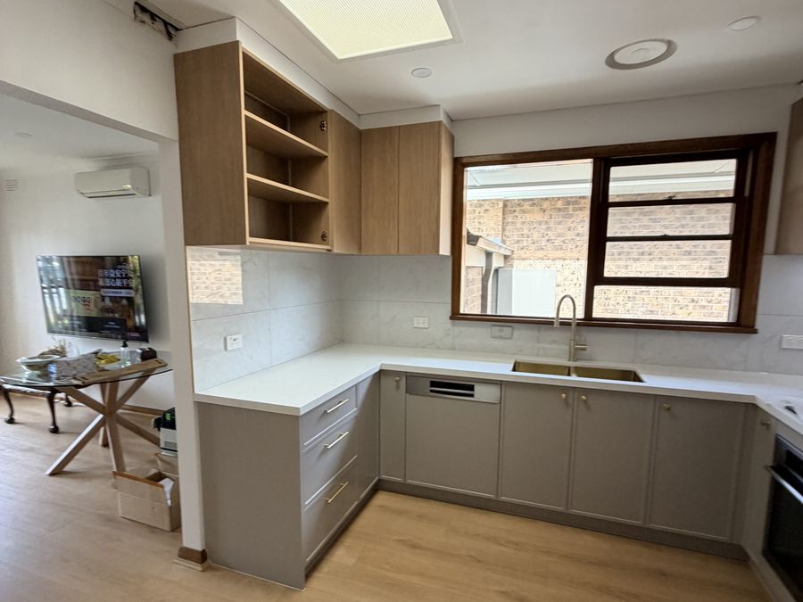 Completed kitchen with timber flooring and stone benchtop