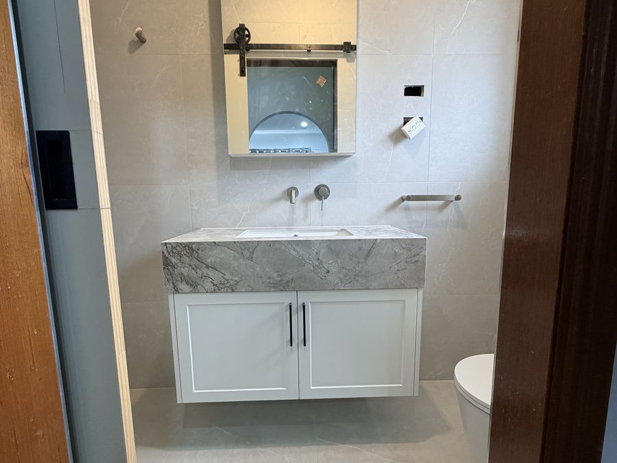 Stone-topped vanity with mirror cabinet